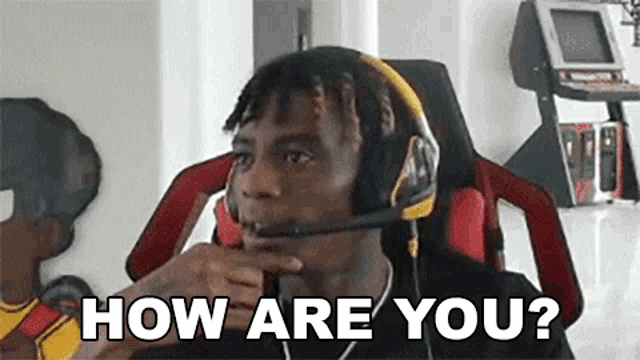 a man wearing headphones and a microphone is asking how are you ?