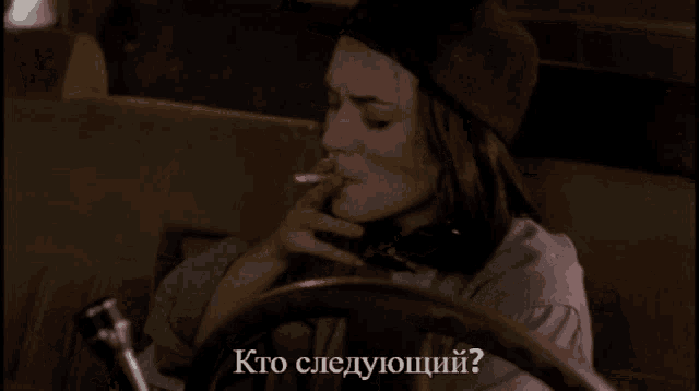 a woman talking on a cell phone with a plane in the background and the words " kto следующий " written below her