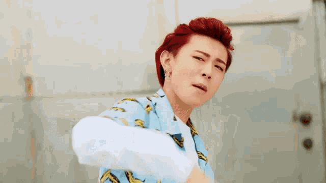 a man with red hair and a blue shirt with bananas on it