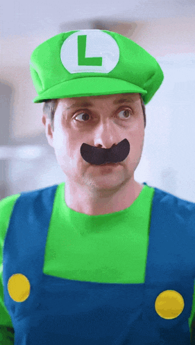 a man in a luigi costume with a green hat and mustache