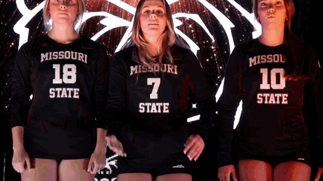 three missouri state volleyball players stand together