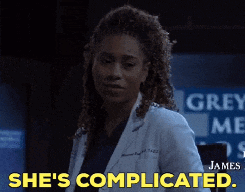 a woman in a lab coat says she 's complicated in yellow letters