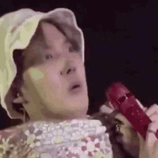 a close up of a person holding a microphone .