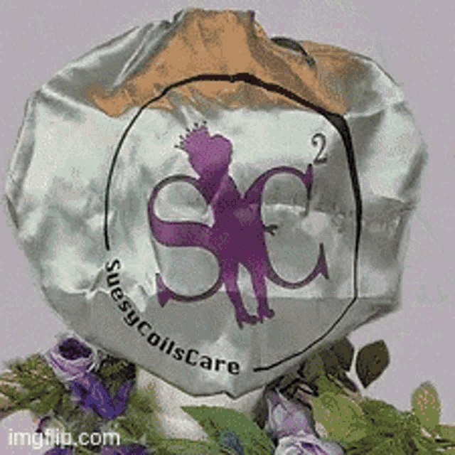 a silver hat with a purple s on it