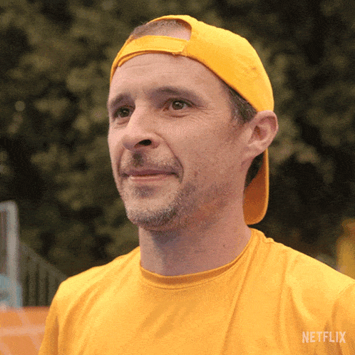 a man wearing a yellow shirt that says netflix on the back