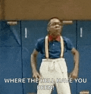 a man wearing goggles and a graduation cap and gown is talking to someone .