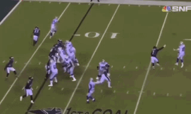 a football game is being played in front of a banner that says catch on it