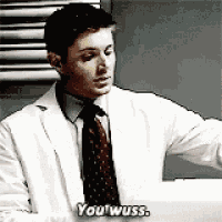 a man in a white lab coat and tie is talking to someone .