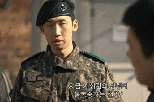 a man in a military uniform is talking to another man in another language