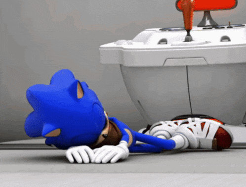 sonic the hedgehog is laying on the floor in front of a white object