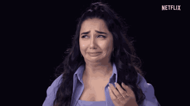 a woman is crying with a netflix logo in the corner