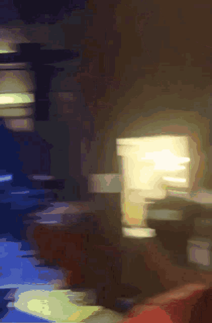 a blurry picture of a person sitting on a couch in a dark room