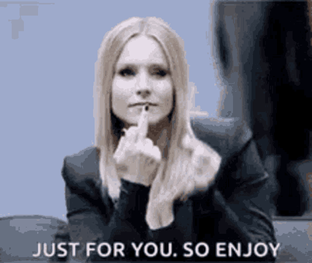 a woman is giving the middle finger to the camera .