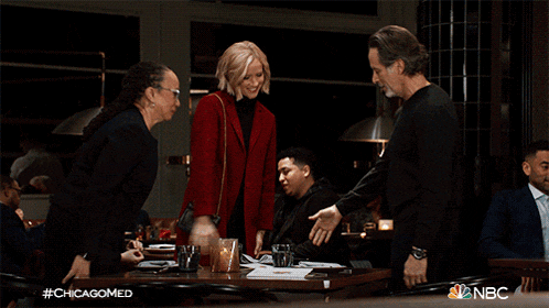 a man and a woman are sitting at a table with nbc written on the bottom of the image