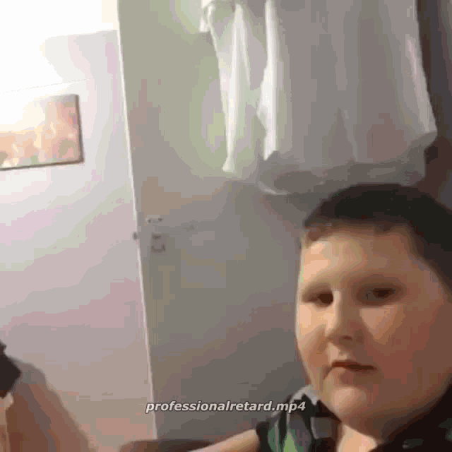 a picture of a boy with the words professional retard.mp4 on the bottom right