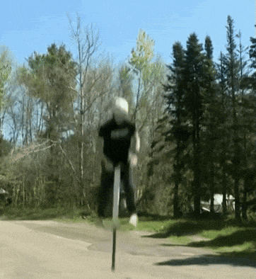 a person is riding a pogo stick on a street