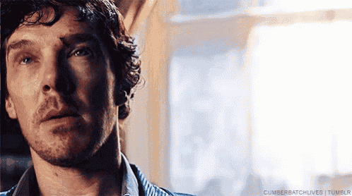 a close up of a man 's face with a beard and a striped shirt .