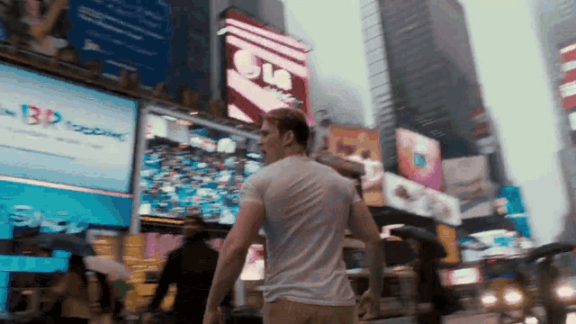 a man in a white shirt is walking down a city street in front of a bp ice cream sign
