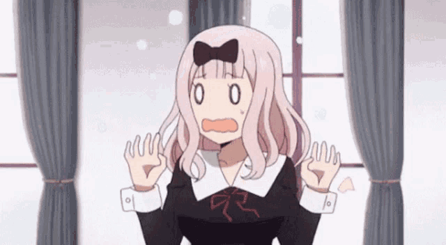a girl with pink hair and a bow on her head is standing in front of a window making a funny face .