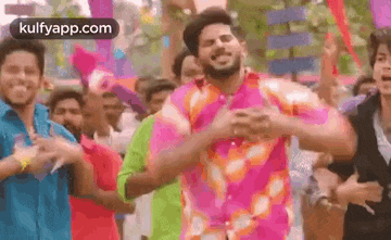 a group of people are dancing in a crowd .