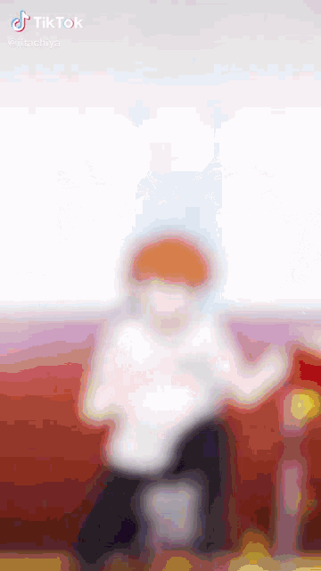 a blurry picture of a person dancing on a tiktok