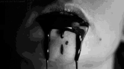 a black and white photo of a person 's mouth with blood dripping from it .