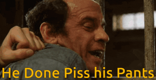 a close up of a man with the words he done piss his pants behind him