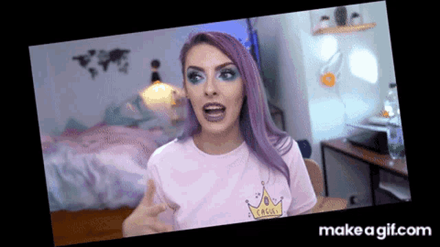 a girl with purple hair is wearing a pink shirt that says cherry on it