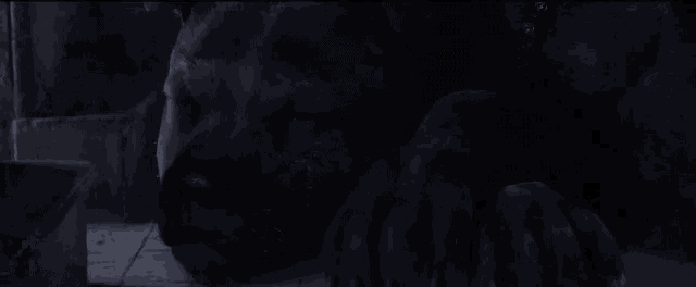 a statue of a man laying down in the dark with his eyes closed .
