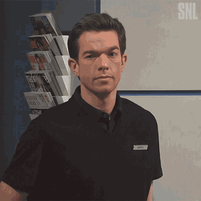 a man in a black shirt with a name tag that says beth