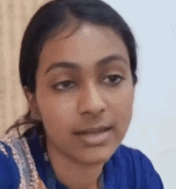 a close up of a woman 's face in a blue shirt .