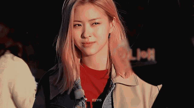 a girl with pink hair is wearing a denim jacket