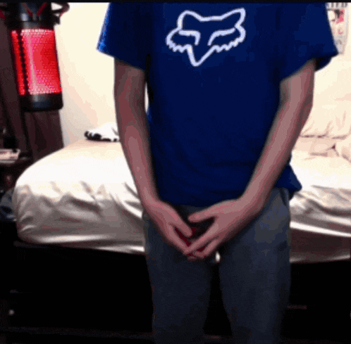 a person wearing a blue shirt with a white fox logo