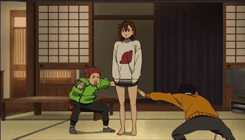 a girl in a sweater with a red heart on it is standing next to two other people