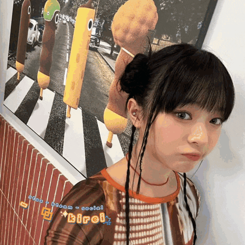 a girl is standing in front of a picture of the beatles and the word kiroi is on her shirt