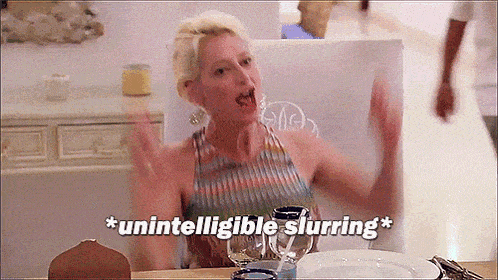 a woman is sitting at a table with her arms outstretched and the words " unintelligible slurring " written above her