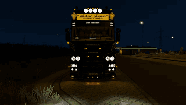 a black truck with a yellow sign that says michael transport on it