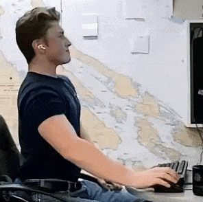 a man is sitting at a desk with a computer mouse