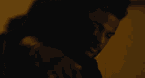 a man and a woman are hugging in the dark .