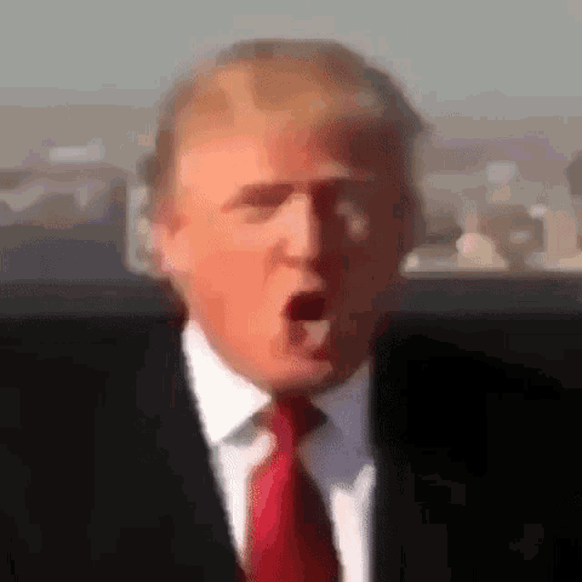 donald trump is wearing a suit and tie with his mouth open .