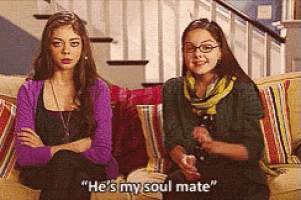 two girls are sitting on a couch and one of them is saying he 's my soul mate