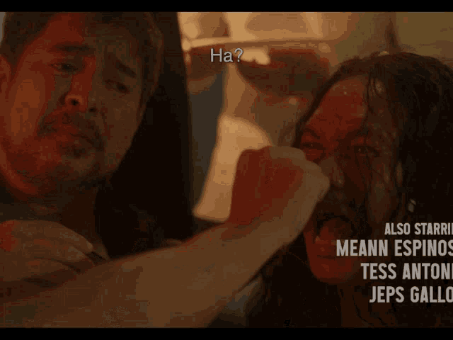 a man is holding a woman with blood on her face and the words " ha " are above them