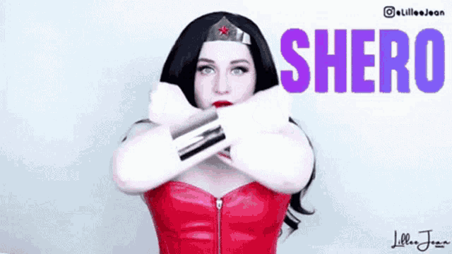a woman in a wonder woman costume with the word shero written on the bottom