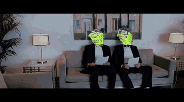 two men in tuxedos sit on a couch with their faces painted to look like cartoon characters
