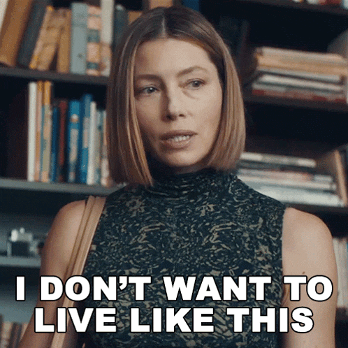 a woman says i don 't want to live like this in front of a bookshelf