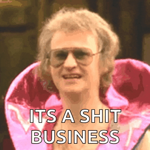 a man wearing sunglasses and a pink jacket with the words " it 's a shit business " on the bottom
