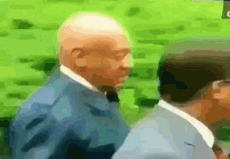 a man in a suit and tie is walking with another man