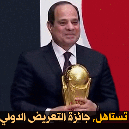 a man in a suit and tie holding a trophy