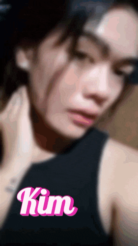 a blurry photo of a woman with the name kim on the bottom right