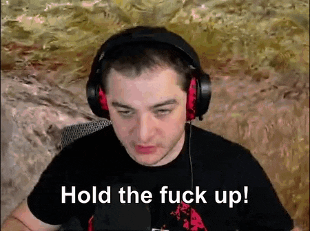 a man wearing headphones says hold the fuck up .